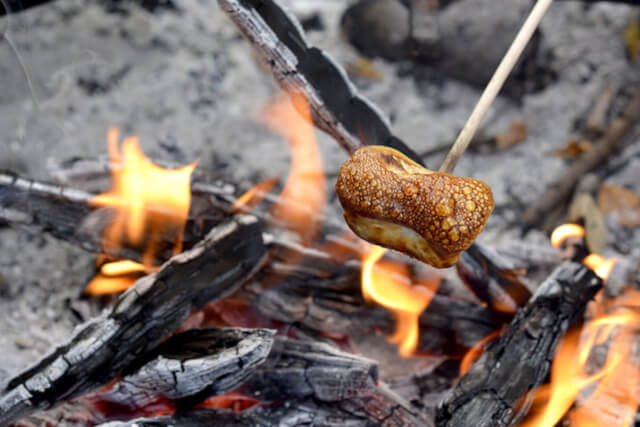 A marshmallow roasting on an open fire